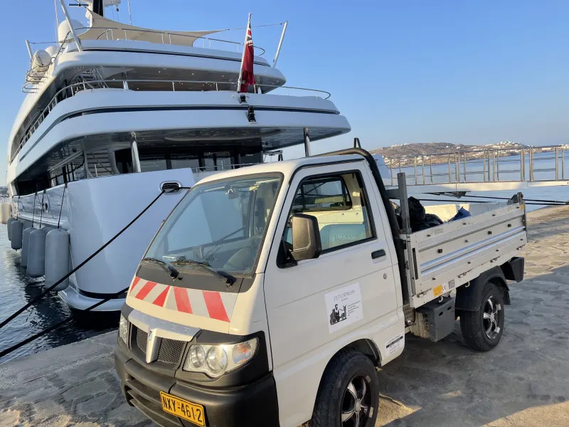 PLP Express truck next to a superyacht at the port